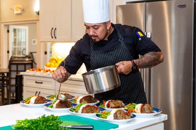 Chef preparing meal plates in a modern kitchen setting