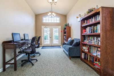 Bright interior of a common area with bookshelves and computers