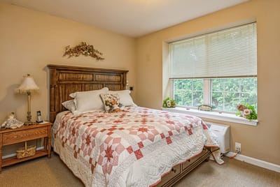 Cozy resident bedroom with a quilt and window view