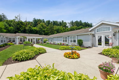 Exterior view of a senior living facility with landscaped gardens