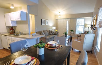 Bright interior common area with seating and dining space