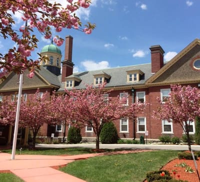 Exterior view of the facility with flowering trees