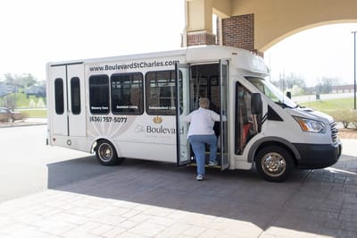 Resident boarding a transport vehicle outside the facility