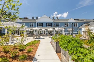 Exterior view of assisted living facility with outdoor seating