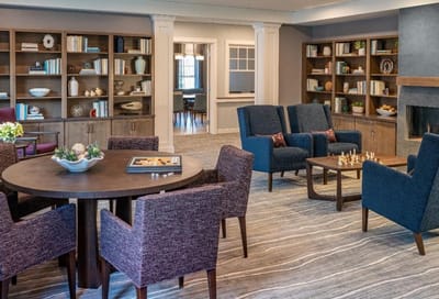 Bright common area with seating and bookshelves