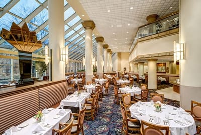 Elegant dining room with tables set for meals