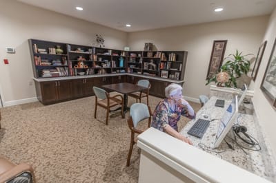 Resident using a computer in a cozy common area