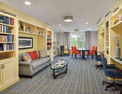 Cozy common area with seating and bookshelves