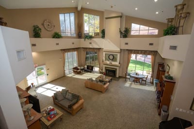 Bright common area with large windows and seating