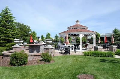 Outdoor gazebo area with seating and landscaping