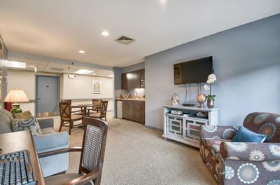 Bright common area with seating and kitchen