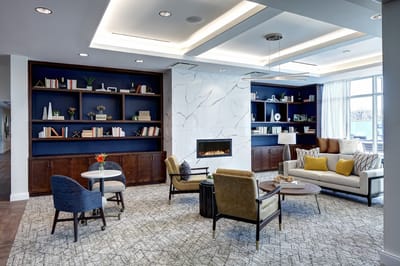 Bright common area with comfortable seating and bookshelves