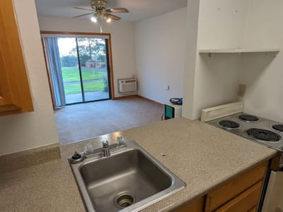 Interior view of a senior living unit with kitchen and living space