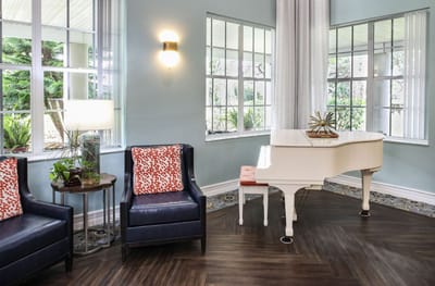 Cozy common area with a grand piano and seating