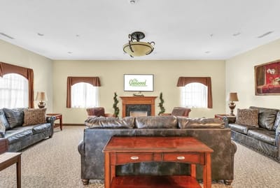 Bright common area with couches and a fireplace