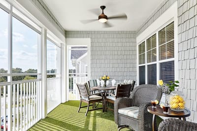 Cozy outdoor balcony with table and chairs