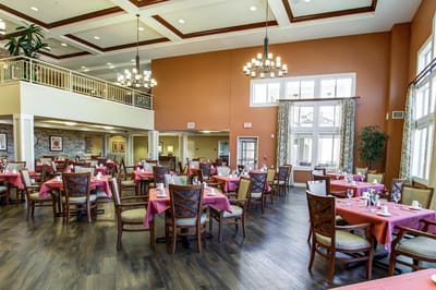 Bright dining room with tables set for residents