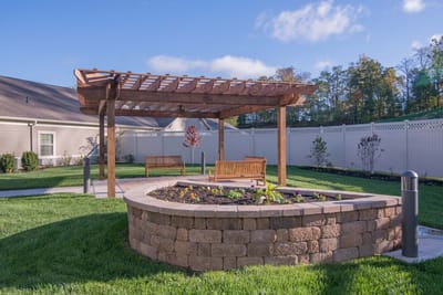 Outdoor seating area with a pergola and garden.