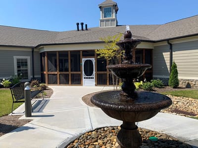A courtyard with a fountain and building entrance