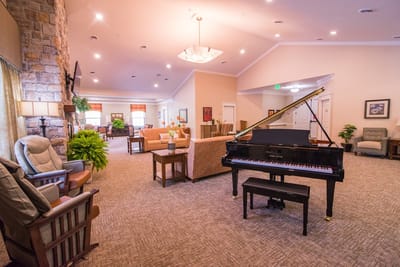 Interior view of a cozy common area with a piano