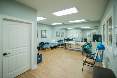 Rehabilitation treatment room with equipment and furniture