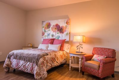 Cozy bedroom with floral decor and bedside lamp