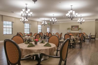 Dining room with elegantly set tables and chandeliers