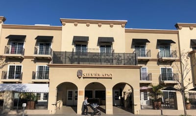 Front exterior of the assisted living facility with a resident