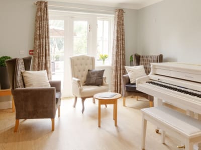 Bright common area with piano and seating