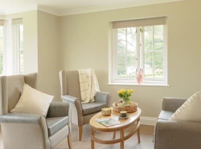 Cozy common area with chairs and table by the window