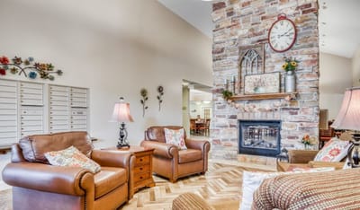 Cozy lounge area with stone fireplace and comfortable seating
