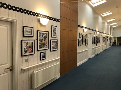 Interior hallway with framed photographs on the walls