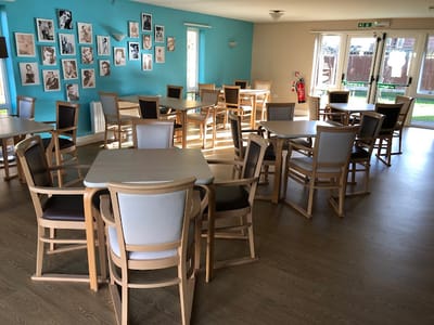 Bright common area with wooden tables and blue walls