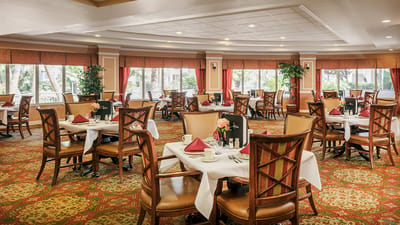 Bright dining room with tables set for meals
