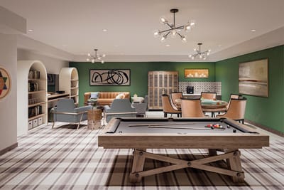 Interior view of a game room with pool table and seating