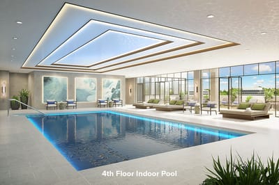 Modern indoor pool featuring lounge chairs and natural light