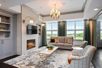 A cozy common area with a fireplace and seating