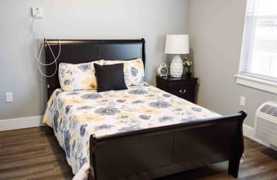 Cozy bedroom with floral bedding and lamp