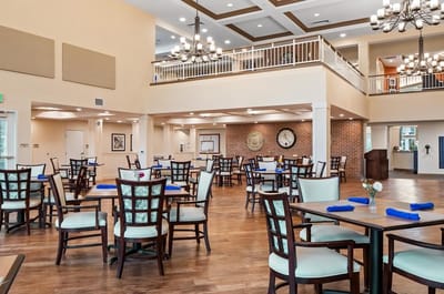 Bright dining room with tables and chairs set up