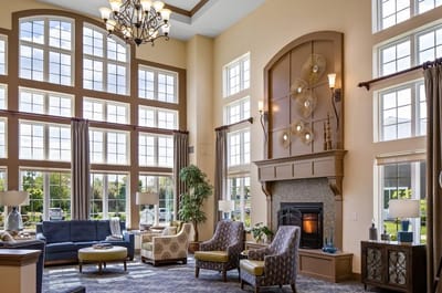 Bright common area with large windows and seating