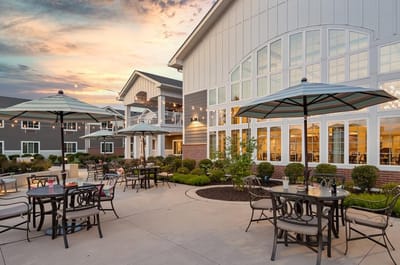 Outdoor seating area with umbrellas and landscaping