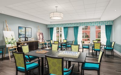 Bright common area with tables and artwork