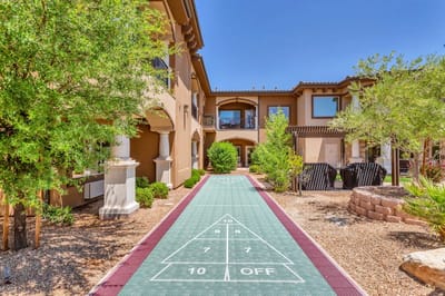 Outdoor space with a shuffleboard court and seating area