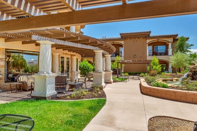 Exterior view of a senior living facility with outdoor seating