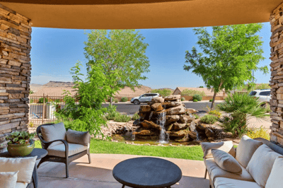 Outdoor seating area with a water feature and landscaping