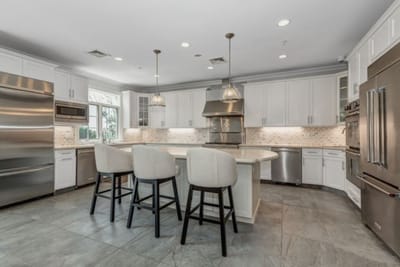 Modern kitchen design with bar seating and stainless appliances