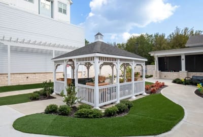 Outdoor gazebo nestled in a landscaped area