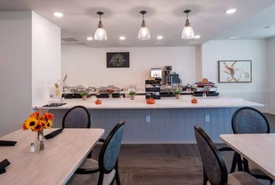 Bright dining area with tables and food setup
