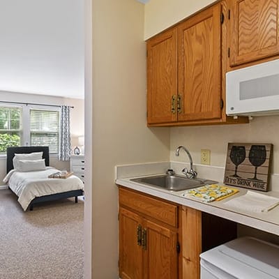 Cozy kitchenette area with a bedroom visible