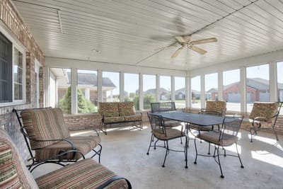 Screened-in porch area with seating